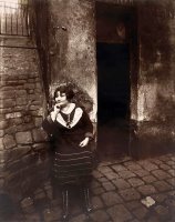 La Villette. Rue Asselin, Prostitute Waiting in Front of Her Door by Eugene Atget
