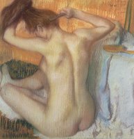 Woman combing her hair by Edgar Degas