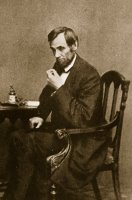 Abraham Lincoln Sitting At Desk by Mathew Brady